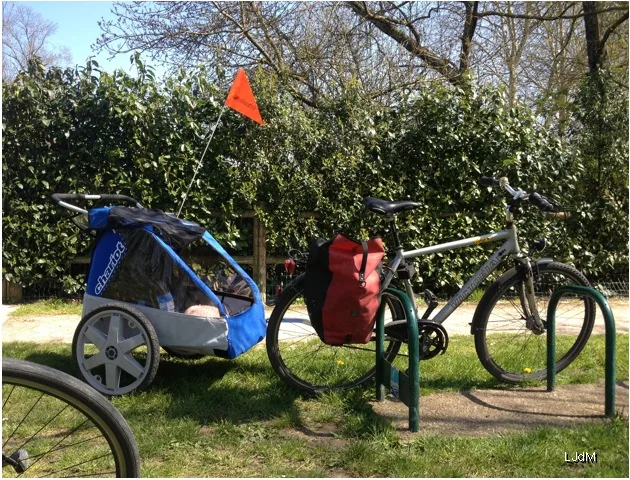 Bicycle with a trailer parked in a park in the Lot