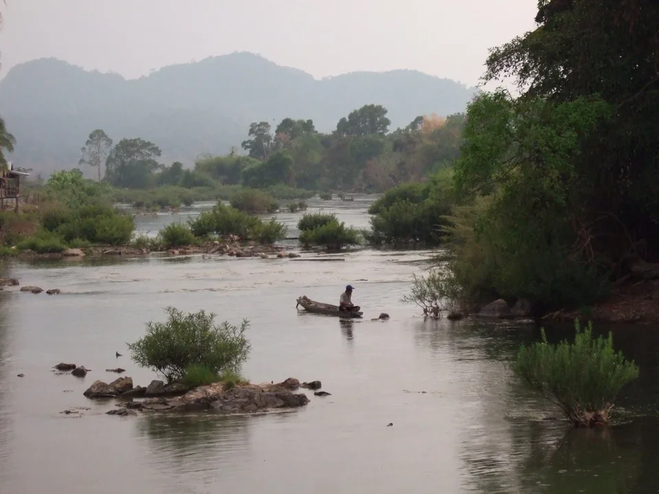 Landscape of a river and forested mountains in Laos