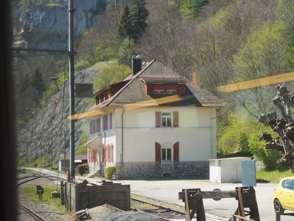 Bâtiment de la gare rurale vu depuis un train qui passe