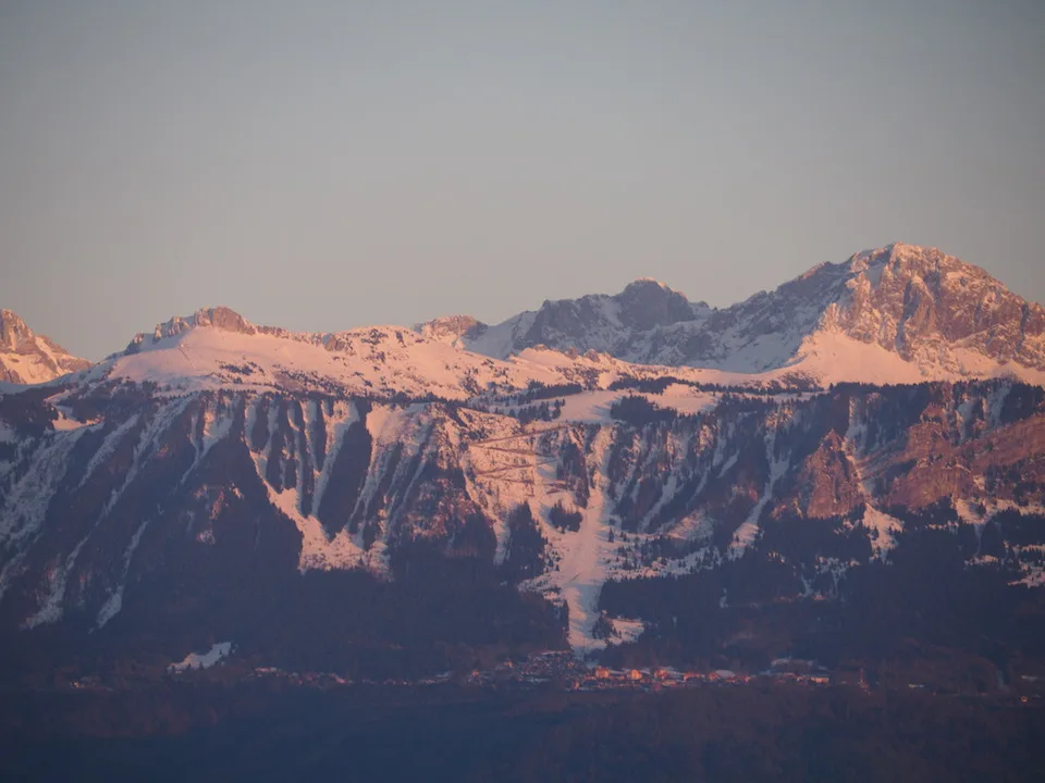 Sommets alpins enneigés brillant dans la lumière du soir