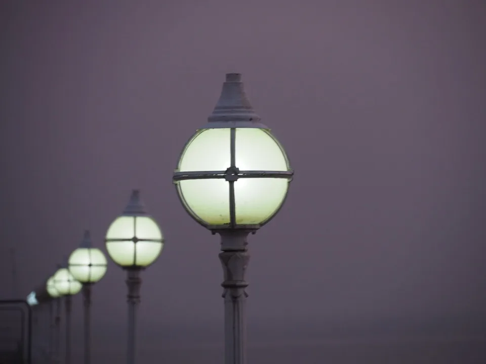 Row of lamps in the mist on Torquay seafront