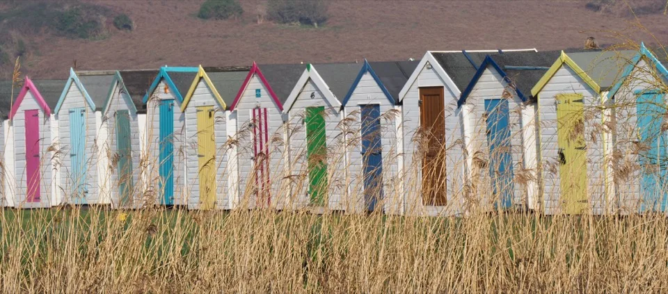 Row of colourful beach huts in Devon