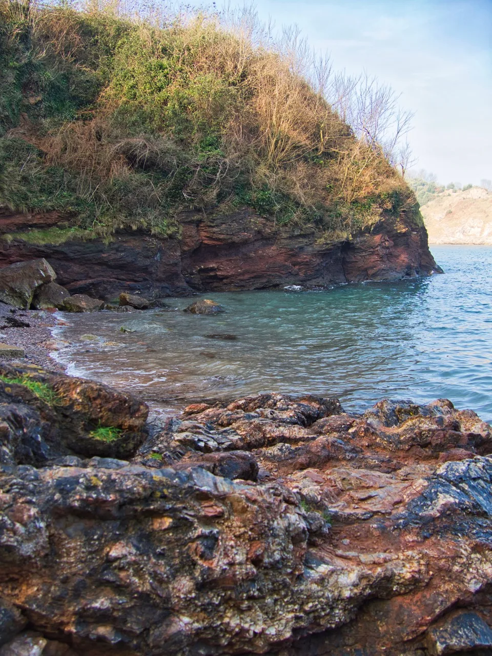 Small rocky cove with clear water in Devon