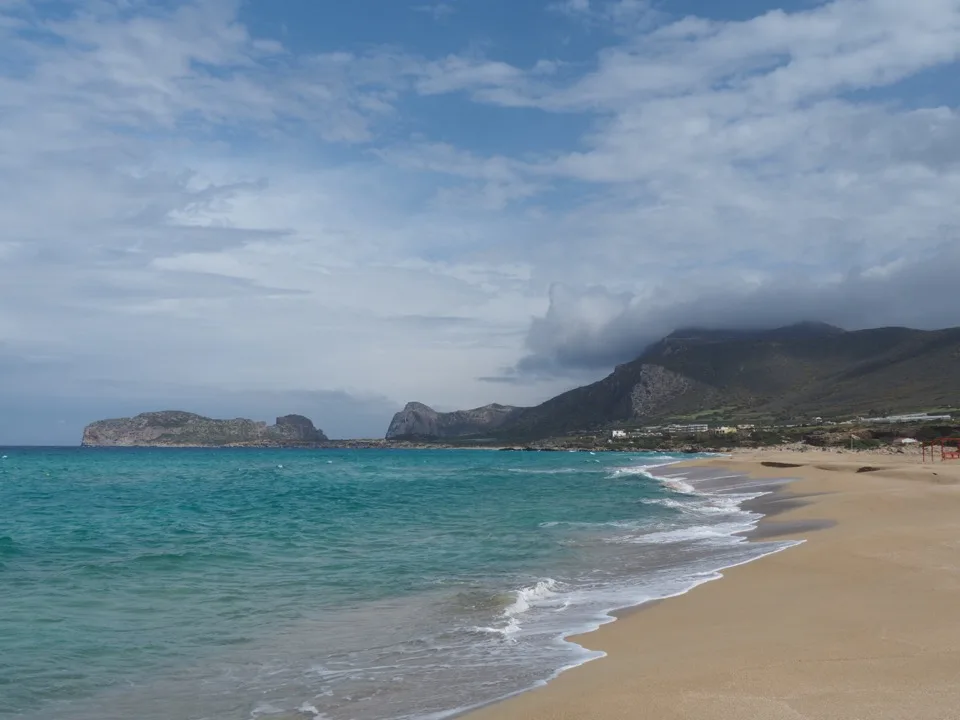 View of a long Cretan beach beneath the mountains