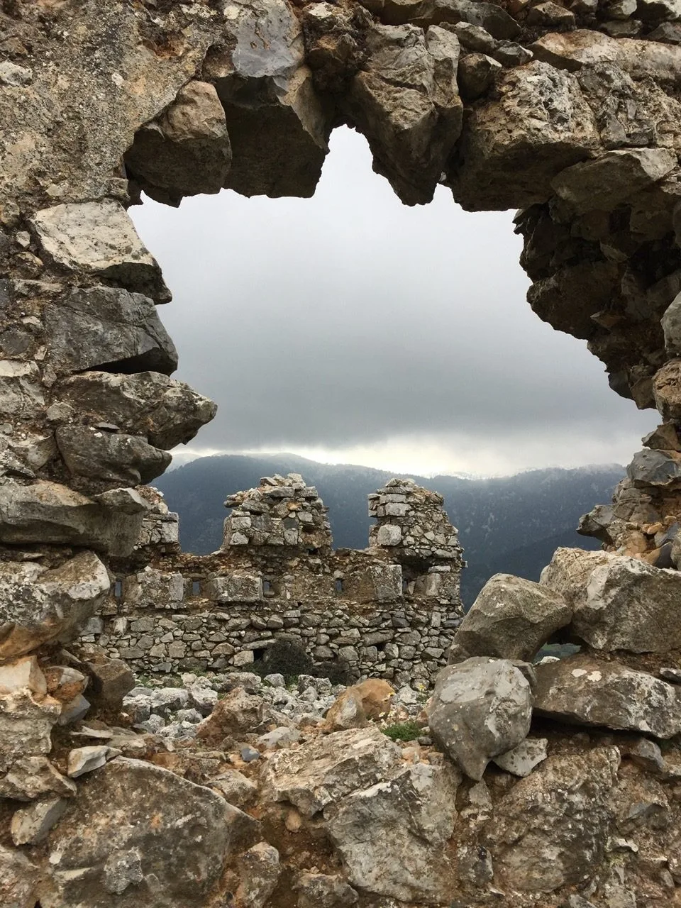 Sea view through a stone arch in Crete